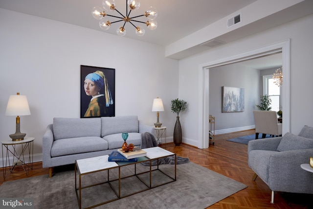 living room featuring baseboards, visible vents, and an inviting chandelier