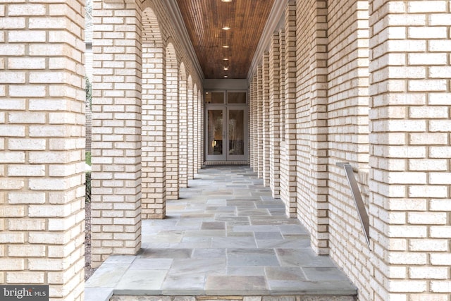 doorway to property with brick siding