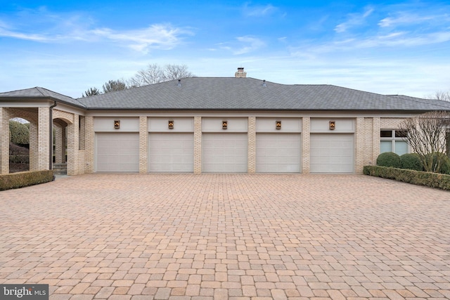 garage featuring decorative driveway