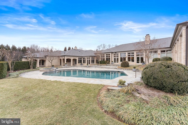 view of swimming pool with a yard, a patio area, and a pool with connected hot tub