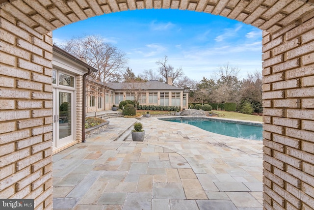 outdoor pool featuring a patio area