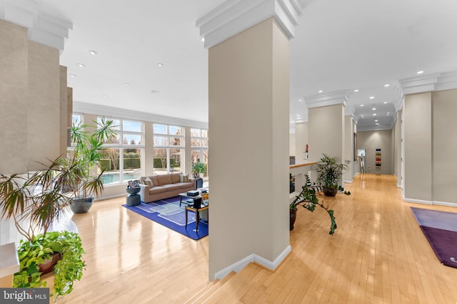 interior space with light wood-type flooring, crown molding, baseboards, and recessed lighting