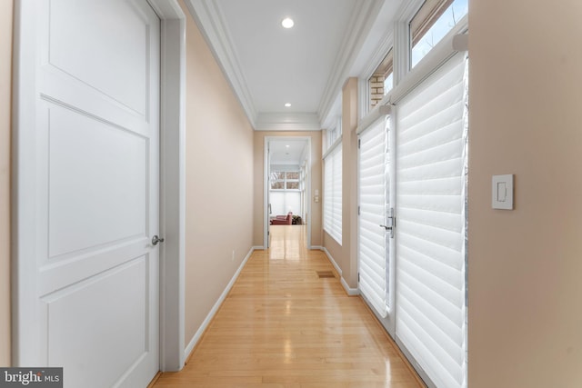 corridor featuring visible vents, baseboards, light wood-style flooring, crown molding, and recessed lighting