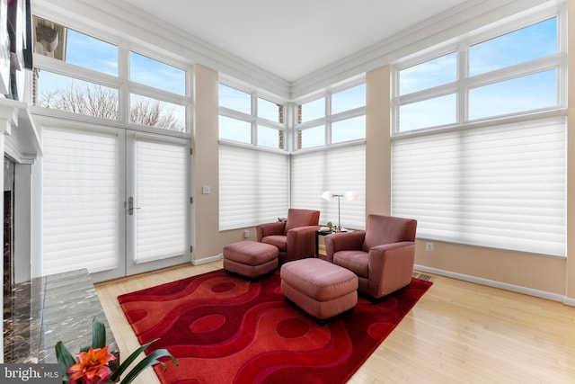 sitting room featuring light wood-type flooring and baseboards