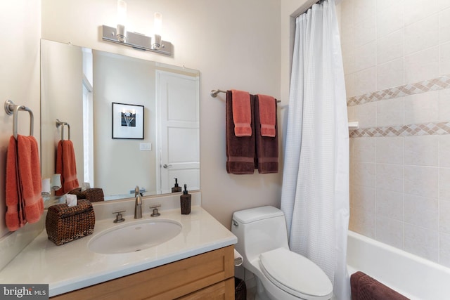 bathroom featuring toilet, shower / bath combo with shower curtain, and vanity