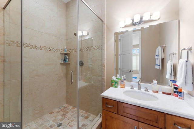 bathroom with a stall shower and vanity