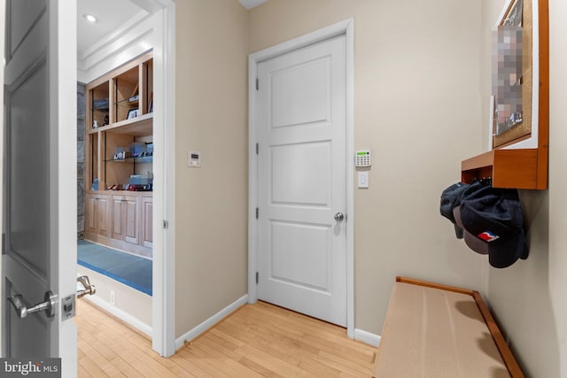 interior space featuring baseboards and light wood-style floors