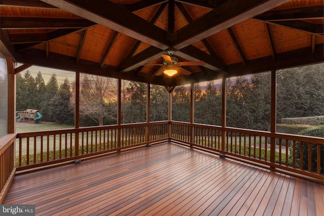 unfurnished sunroom with a ceiling fan and lofted ceiling with beams