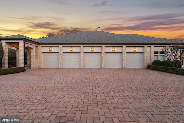 garage with decorative driveway