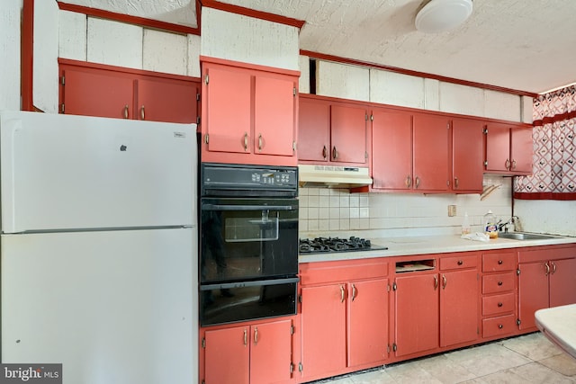 kitchen with red cabinets, under cabinet range hood, light countertops, black appliances, and a sink