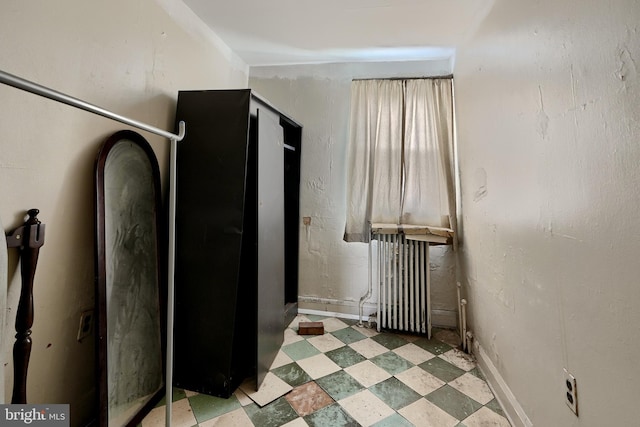 interior space with baseboards and tile patterned floors