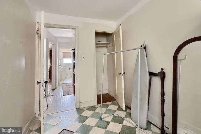 corridor with light floors and baseboards