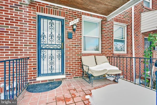 property entrance featuring brick siding