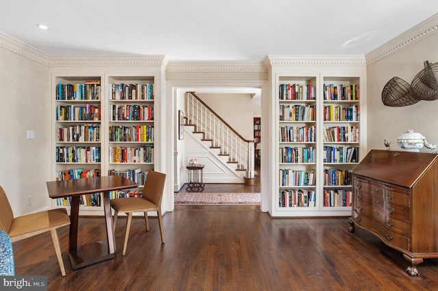 living area featuring stairs, built in shelves, wood finished floors, and ornamental molding