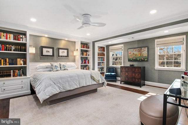 bedroom with recessed lighting, baseboards, multiple windows, and wood finished floors