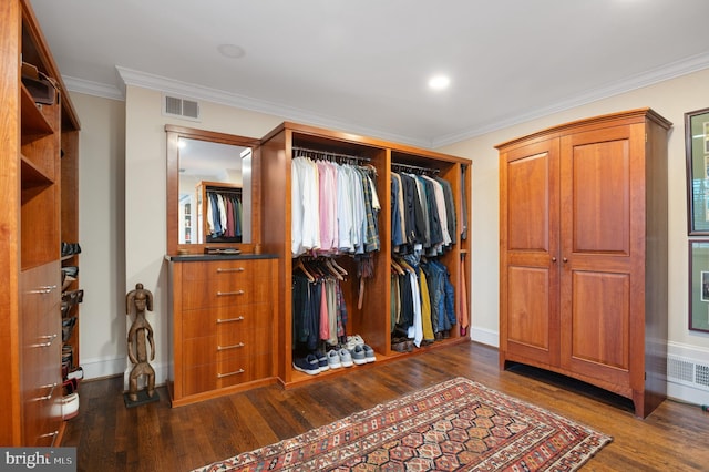 interior space featuring visible vents, dark wood-type flooring, ornamental molding, radiator, and baseboards