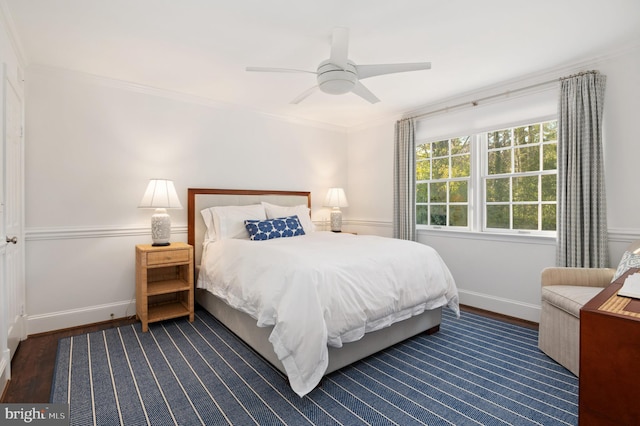 bedroom featuring wood finished floors, baseboards, and ornamental molding