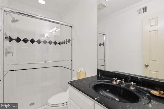 bathroom featuring visible vents, toilet, a shower stall, crown molding, and vanity