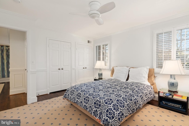 bedroom with a ceiling fan, crown molding, and wood finished floors