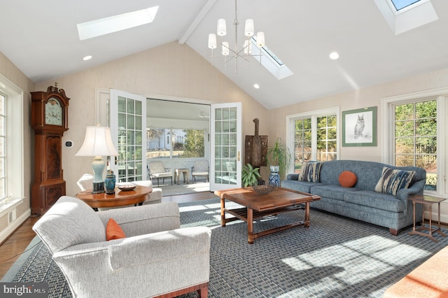 living area featuring an inviting chandelier, lofted ceiling with skylight, recessed lighting, and wood finished floors