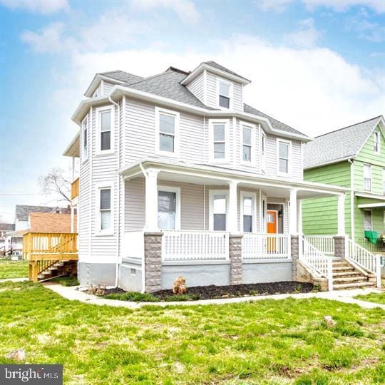 traditional style home with a front yard and covered porch