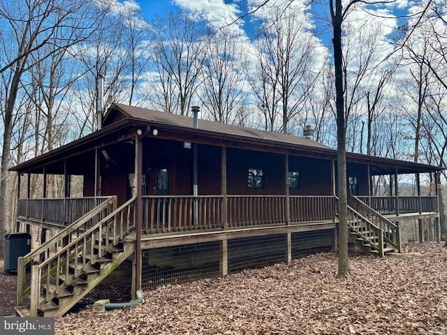 view of front of property with cooling unit, covered porch, and stairs