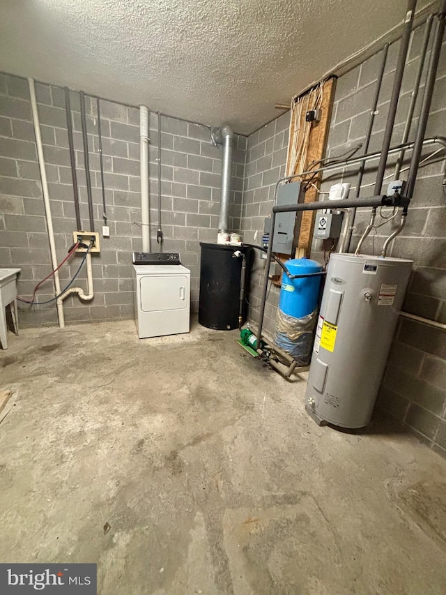 interior space featuring a wood stove, water heater, washer / clothes dryer, and concrete block wall