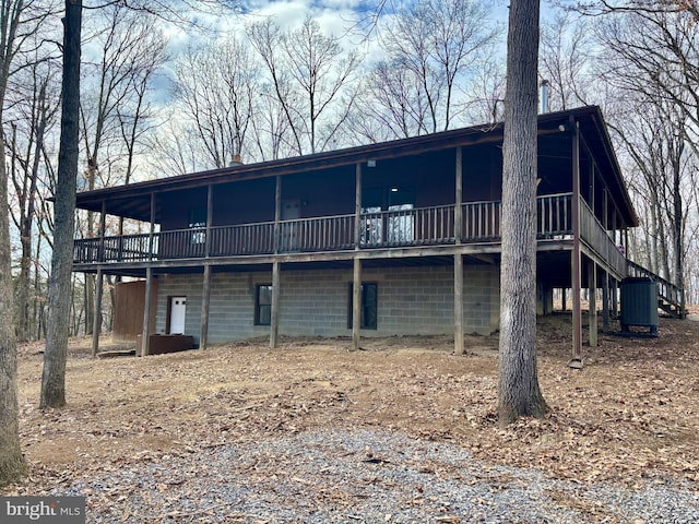 rear view of house featuring a deck and central air condition unit