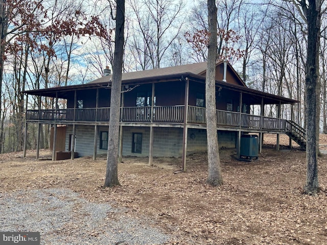 back of property featuring stairway, a wooden deck, and central air condition unit