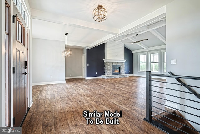 unfurnished living room featuring baseboards, dark wood finished floors, vaulted ceiling with beams, a fireplace, and ceiling fan with notable chandelier