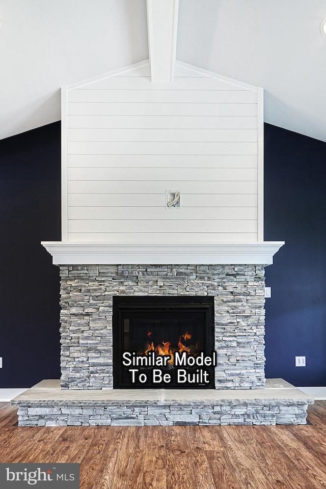 details featuring beam ceiling, a stone fireplace, and wood finished floors