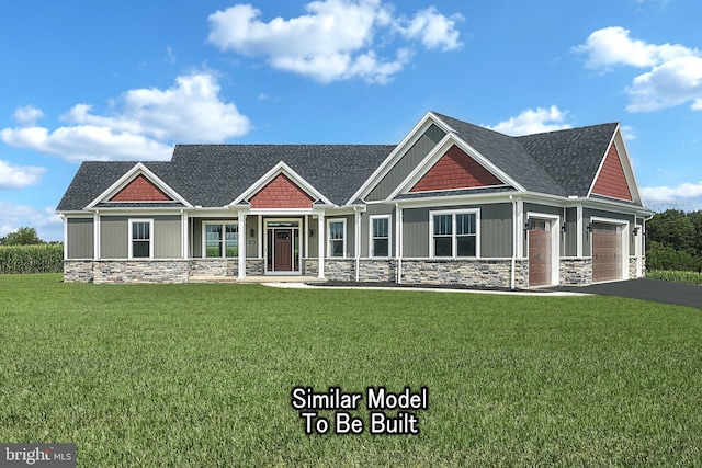 craftsman inspired home with aphalt driveway, an attached garage, stone siding, board and batten siding, and a front yard