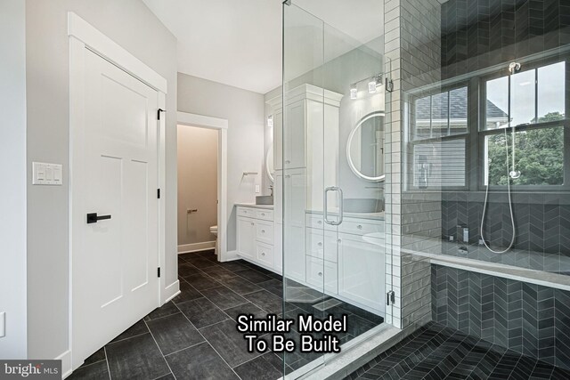 bathroom with a stall shower, baseboards, toilet, tile patterned floors, and vanity