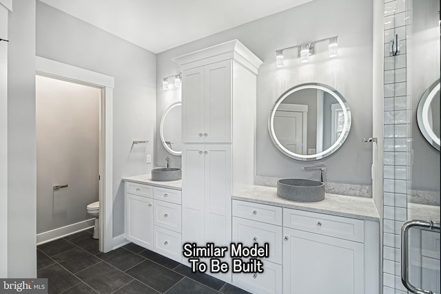 bathroom with tile patterned flooring, a sink, toilet, and double vanity