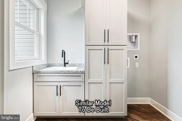 interior space with plenty of natural light, wood finished floors, vanity, and baseboards