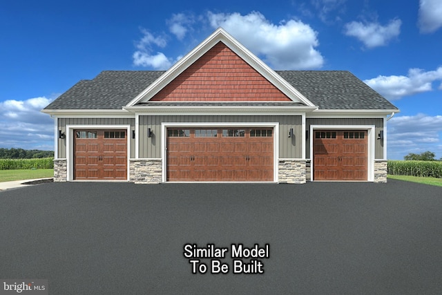 craftsman house featuring board and batten siding, stone siding, a shingled roof, and a garage