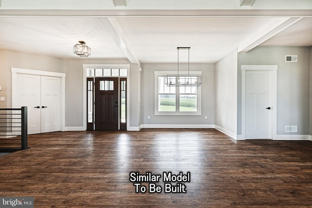 foyer with baseboards, visible vents, and dark wood finished floors