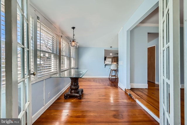 interior space featuring baseboards and wood finished floors