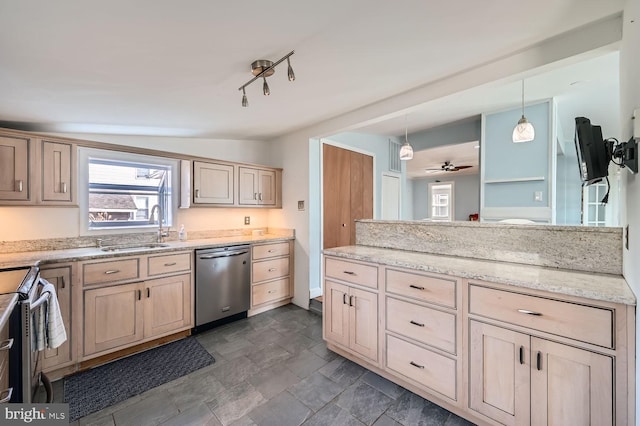 kitchen featuring decorative light fixtures, light stone countertops, stainless steel appliances, light brown cabinets, and a sink