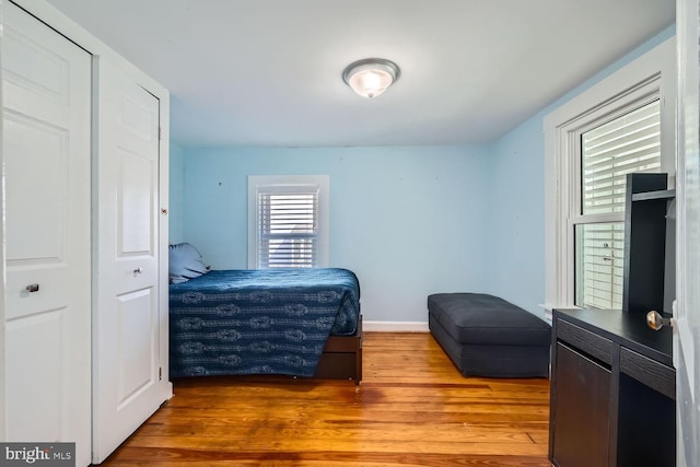 bedroom featuring baseboards and wood finished floors