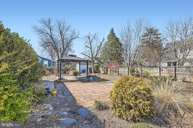 view of yard with fence, a patio, and a gazebo