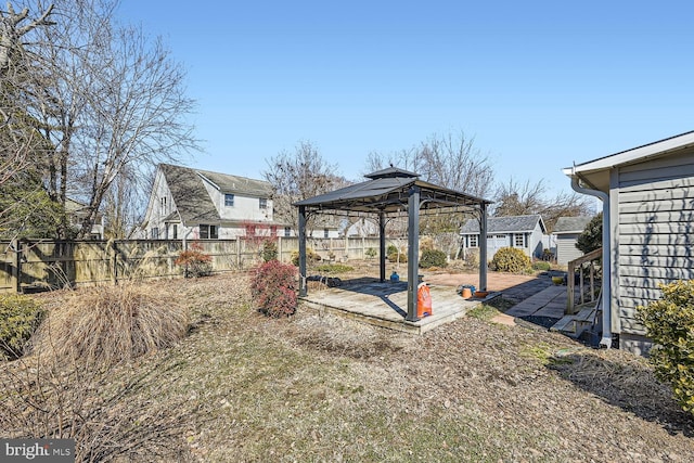 view of yard featuring a fenced backyard, an outbuilding, a patio, and a gazebo