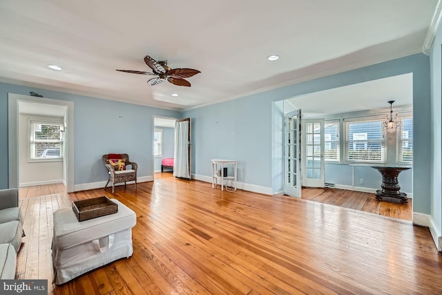 sitting room with light wood finished floors and ornamental molding