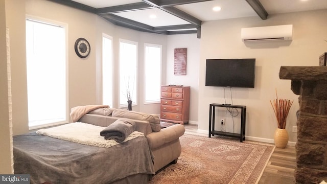 bedroom featuring multiple windows, beam ceiling, an AC wall unit, and wood finished floors