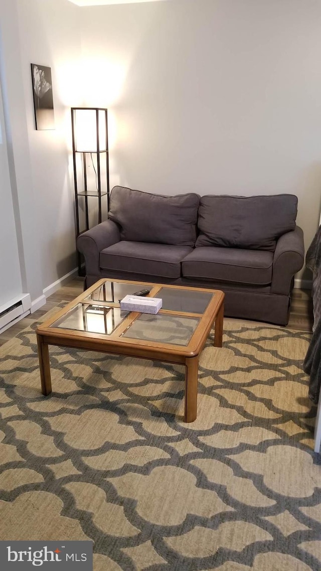 living area featuring baseboards