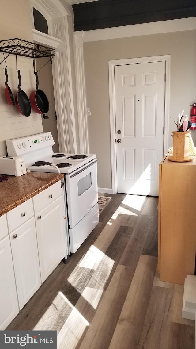 kitchen featuring dark countertops, electric range, white cabinetry, and dark wood finished floors