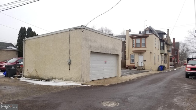 exterior space with a garage and stucco siding