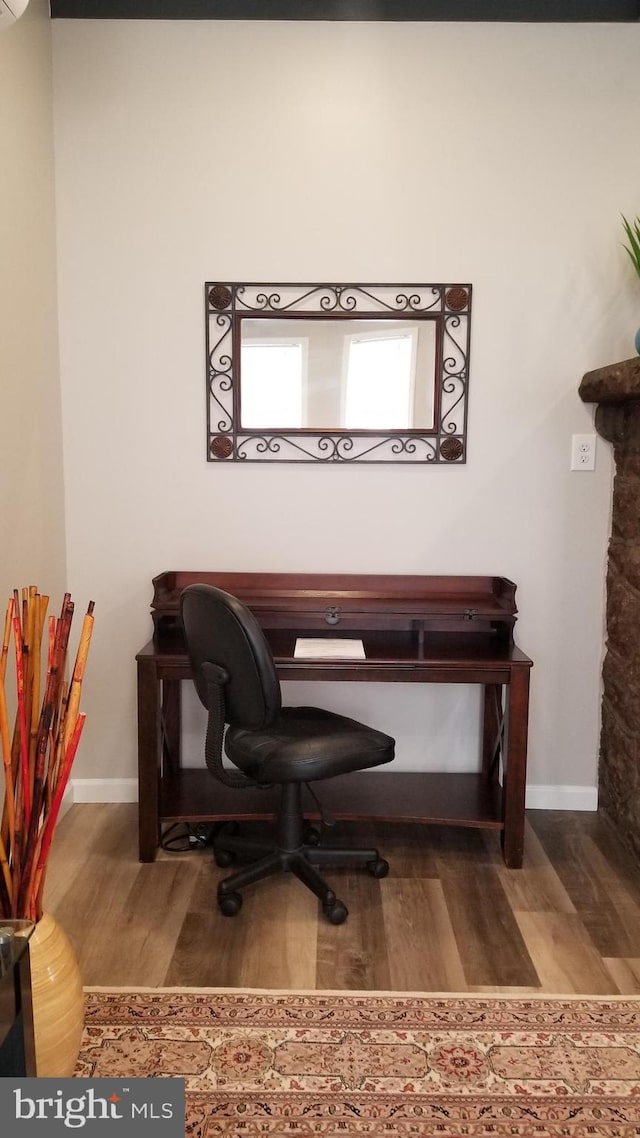 office area with baseboards and wood finished floors