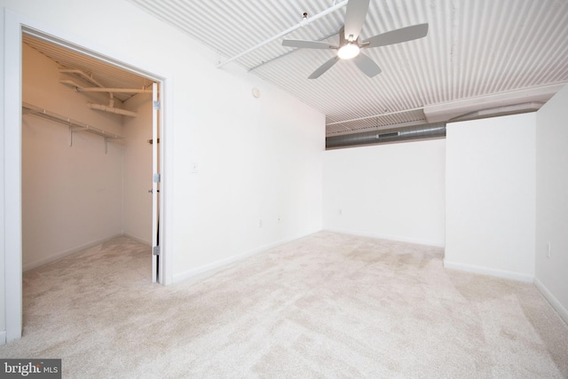 unfurnished bedroom featuring carpet, a spacious closet, and a closet