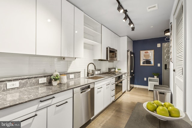 kitchen with white cabinetry, visible vents, appliances with stainless steel finishes, and a sink